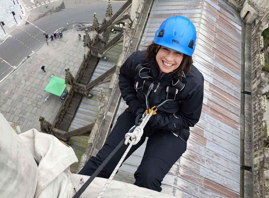 Woman abseiling from building