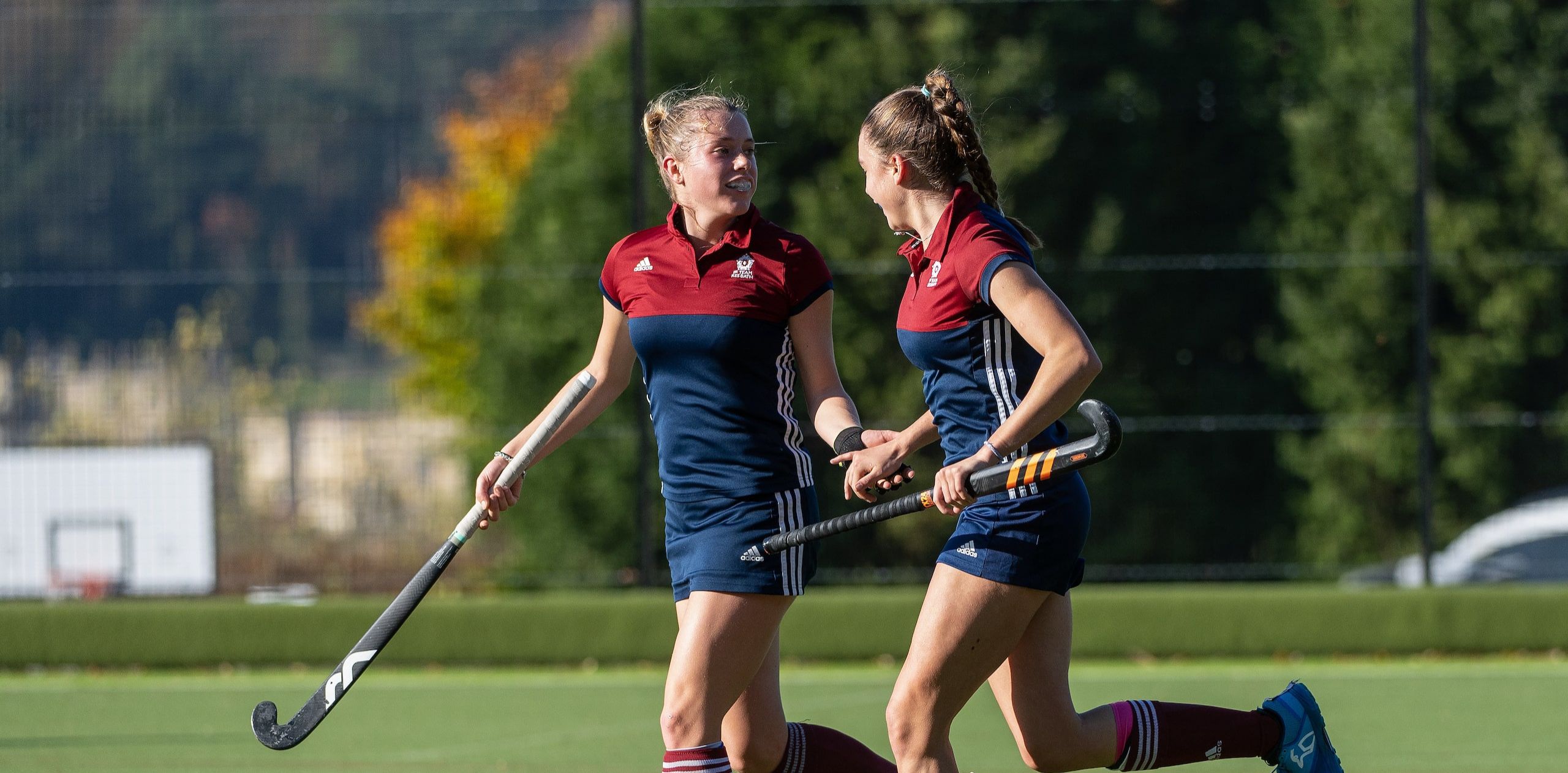 Two girls playing hockey